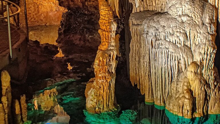 Stalgtites dripping into a cave lake.